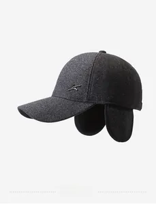 Detail view of winter baseball cap with earflaps in grey tweed texture and metal logo
