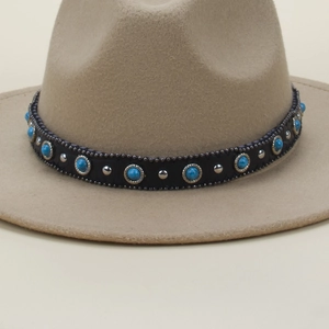 Detail of bohemian fedora hat with turquoise beads and black leather decorative band