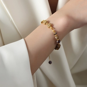 Vintage gold chain bracelet with natural agate beads and freshwater pearls on model wrist
