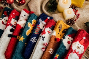 Detailed view of warm Christmas coral fleece socks with festive patterns and soft texture