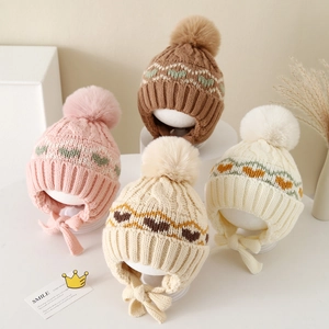 Winter knit earflap hat for kids with heart pattern and faux fur pompom in four soft colors