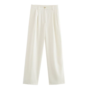 Detailed view of white high-waisted wide-leg trousers with pleated texture and button closure