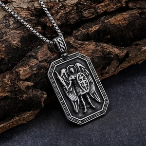 Retro stainless steel Archangel Michael shield pendant necklace on a rustic wood surface