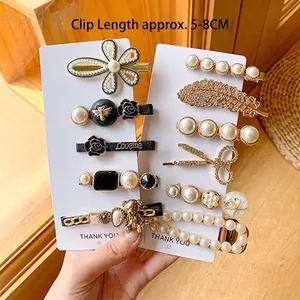 Elegant pearl and gold alloy hair clip set featuring Love Me letter charms and stars
