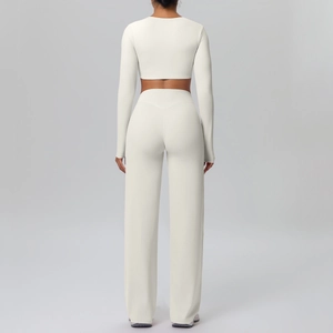 Back view detail of ivory yoga set featuring a long sleeve crop top and flared trousers
