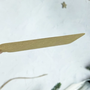 Brown heart-shaped kraft paper gift tag shown from a side view highlighting thickness
