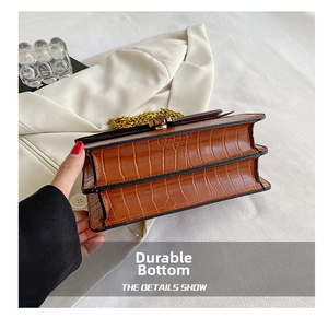 Close-up of brown crocodile texture pattern and durable double-layered base on crossbody bag