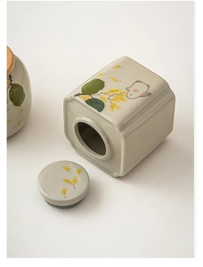 Detailed view of square ceramic tea canister with hand-painted rabbit and osmanthus