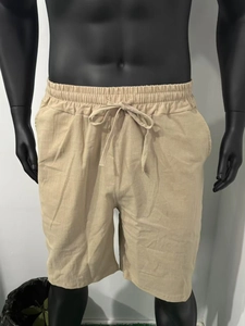 Detail of men's beige linen shorts featuring adjustable drawstring and elastic waistband