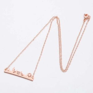 Rose gold necklace featuring a minimalist city skyline silhouette pendant on a fine link chain