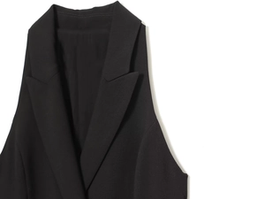 Detail view of high-quality black lapel collar with fine woven texture and neat stitching
