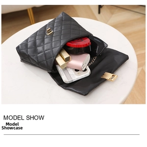 Inside look of black quilted crossbody bag showing storage for phone, lipstick, and sunglasses