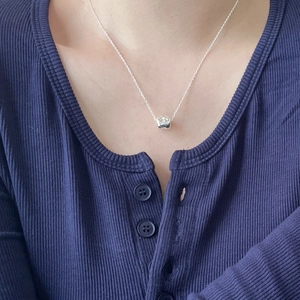 Minimalist 925 sterling silver necklace with heart and sphere pendants on a model