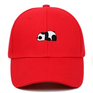 Close-up of red cotton baseball cap featuring detailed black and white panda embroidery