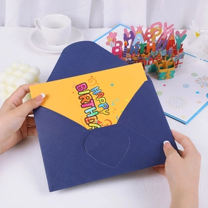 Detailed view of blue envelope with yellow Happy Birthday card and 3D paper pop-up