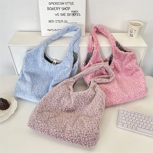 Three plush leopard print tote bags in blue, pink, and rose with soft faux fur texture