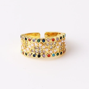 Detail view of gold open ring with colorful zircons and white imitation pearls