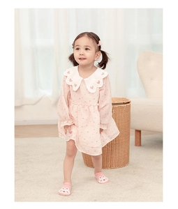 Toddler girl pink heart dress with doll collar and long sleeves in cozy indoor setting