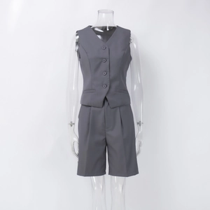 Detail of dark gray V-neck vest and matching tailored shorts on invisible mannequin