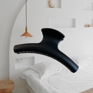 Close-up of a large black matte claw clip featuring a streamlined curved grip design