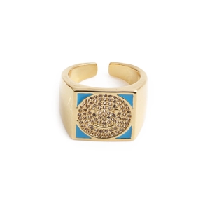 Macro shot of gold square smiley face ring with blue enamel and sparkling zircon inlay