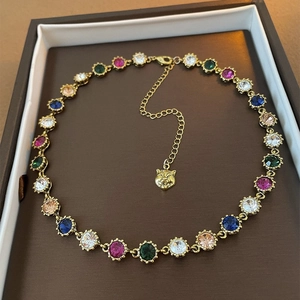 Macro detail of French style double-layer necklace with colorful crystals and tiger head charm