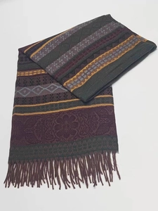 Detail shot of striped ethnic style scarf with colorful patterns and tassel edges