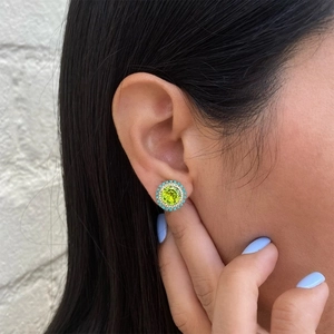 Close-up of S925 sterling silver earring with turquoise and green peridot stone inlay