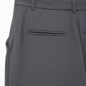 Gray high-waist flared suit trousers with back pocket detail and premium fabric texture