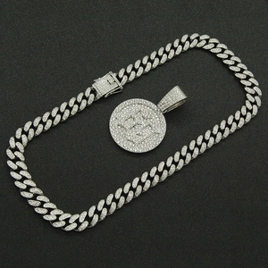Silver iced out Cuban chain necklace with sparkling letter E round pendant on black background