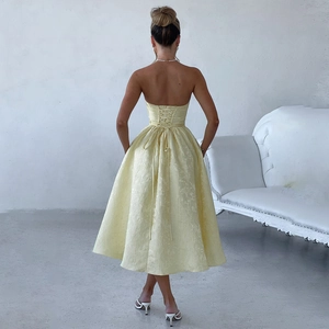 Detail of light yellow strapless dress showing the adjustable lace-up back design