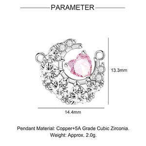 Macro detail of moon and heart pendant with dimensions 13.3mm by 14.4mm in copper zircon
