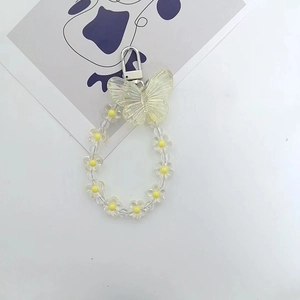 Chic transparent butterfly and yellow flower charm with silver lobster clasp on white background