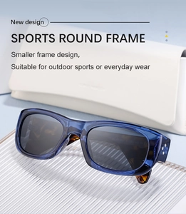 Detail view of sporty round blue frame sunglasses with tortoiseshell temples on a textured surface