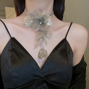 Close-up of silver layered necklace with wirework flower tassels on a female model
