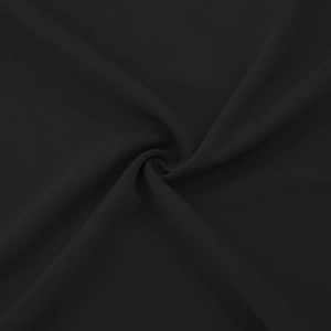 Close-up of premium black composite fabric texture showing soft drape and fine fiber weave