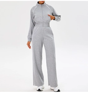 Detail of grey yoga set featuring zip-up cropped hoodie and wide-leg joggers with side stripes