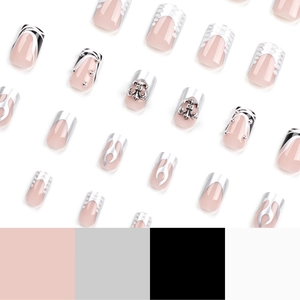 Nude square press-on nails featuring silver flame patterns and gothic cross charms