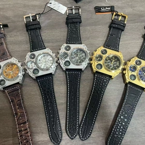Top view of large dual time zone quartz watches with assorted leather straps on wood surface
