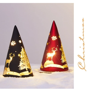 Close-up of conical Christmas lamps with warm glow and cutout reindeer snowflake patterns