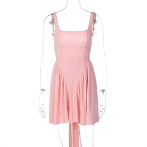 Detail of pink sleeveless mini dress featuring ruffled hem and soft pleated fabric textures