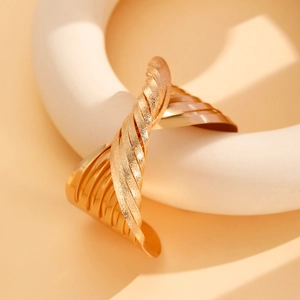 Golden twisted open bangle with combined matte and mirror finish in an artistic design