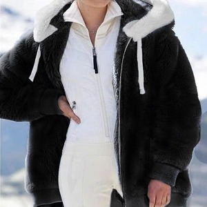 Detail of black faux fur jacket with white plush hood and ribbed windproof cuffs