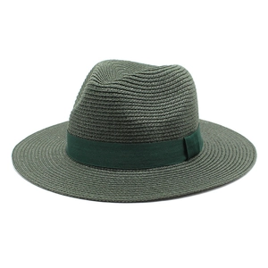 Detail of dark green straw fedora hat featuring close-up texture and grosgrain ribbon bow