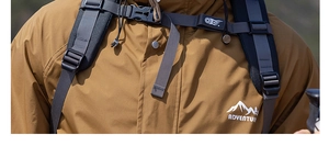 Close-up of tan outdoor adventure jacket fabric texture and durable backpack buckle