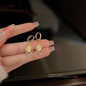 Vintage cat eye stone drop earrings in gold metal with small clear rhinestones
