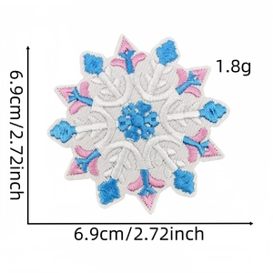 Detail of embroidered snowflake patch with dimensions 6.9cm showing blue and pink stitching