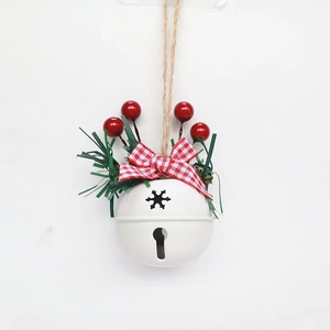 White Christmas bell detail with red berries, pine needles and checkered bow on hemp rope