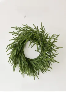 Macro detail of lush green Norfolk pine wreath with realistic PE needles for holiday decor
