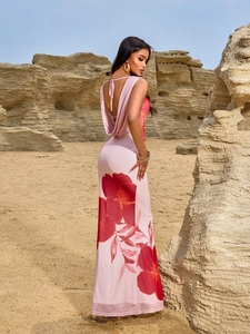 Elegant backless halter maxi dress with floral print against desert rock landscape